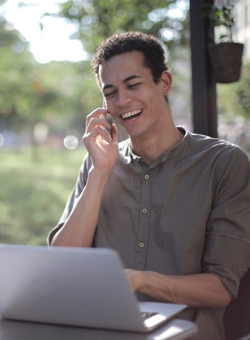 Mann sitzt im Garten am Computer